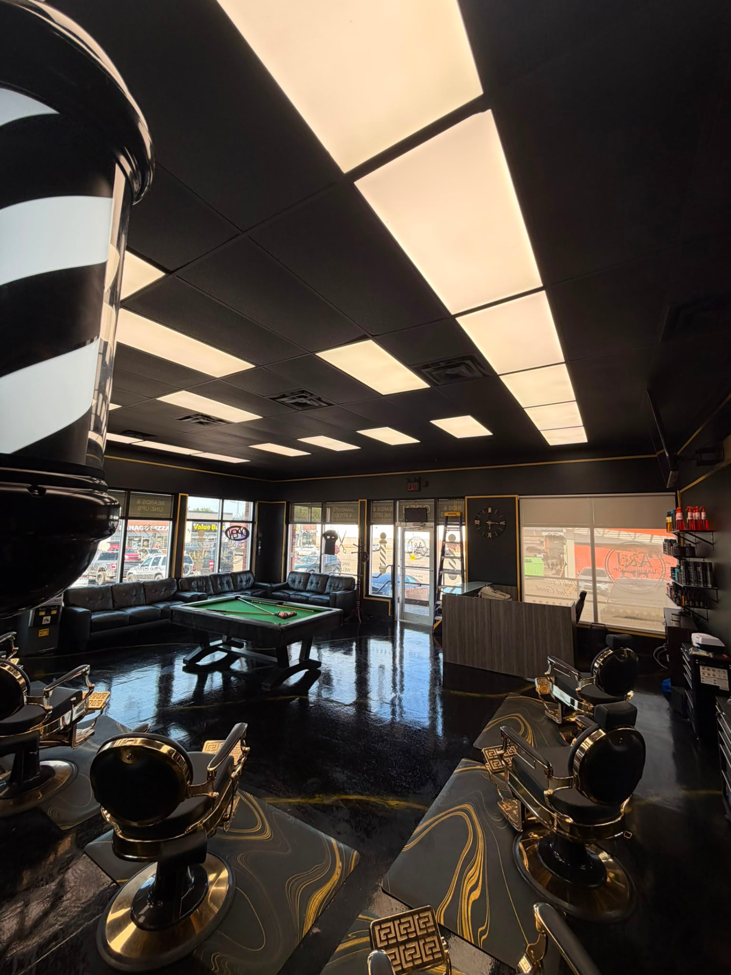 Inside A&J Barbershop on Thickwood Blvd, Fort McMurray — gold barber chairs and lounge